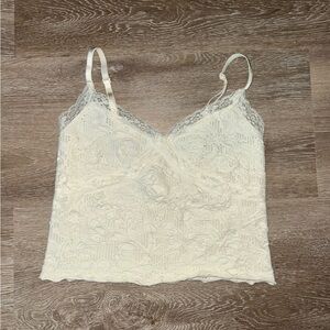 Urban Outfitters cream crop top with flower and lace details.